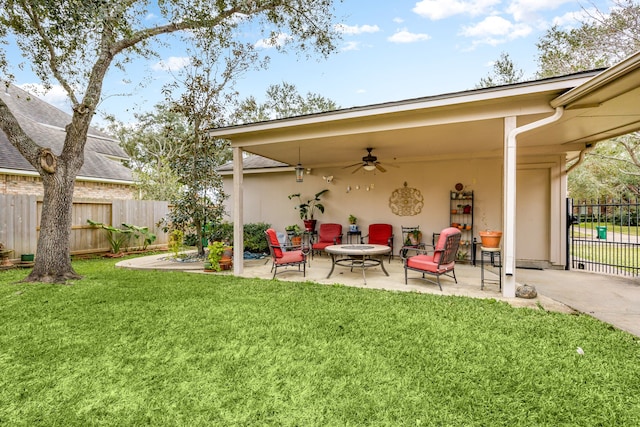 exterior space with a lawn, a patio area, ceiling fan, and a fire pit