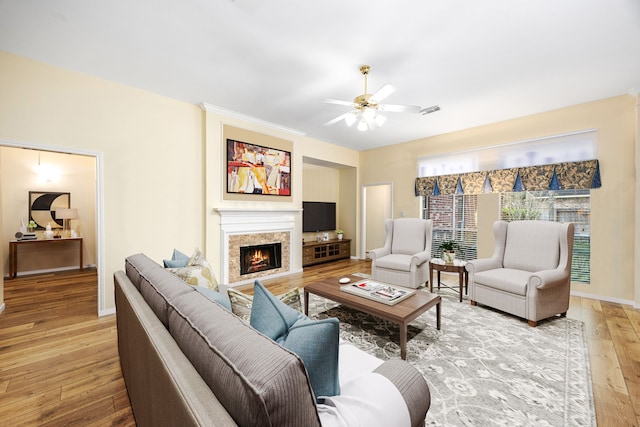 living room featuring light wood-type flooring and ceiling fan