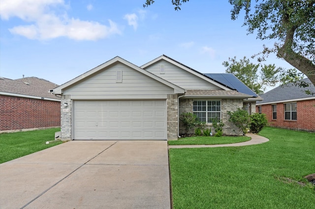 view of front of house featuring solar panels, a front lawn, and a garage