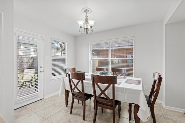 dining room featuring an inviting chandelier and light tile patterned floors