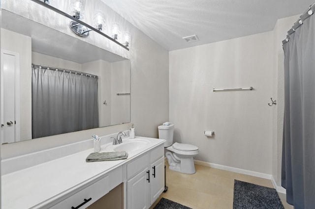 bathroom featuring toilet and vanity