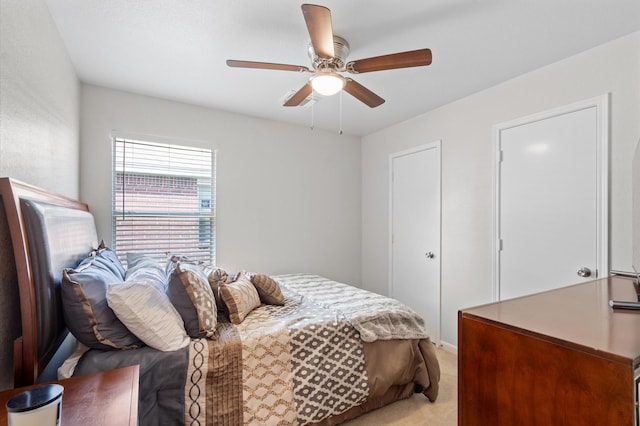 bedroom featuring ceiling fan and light colored carpet