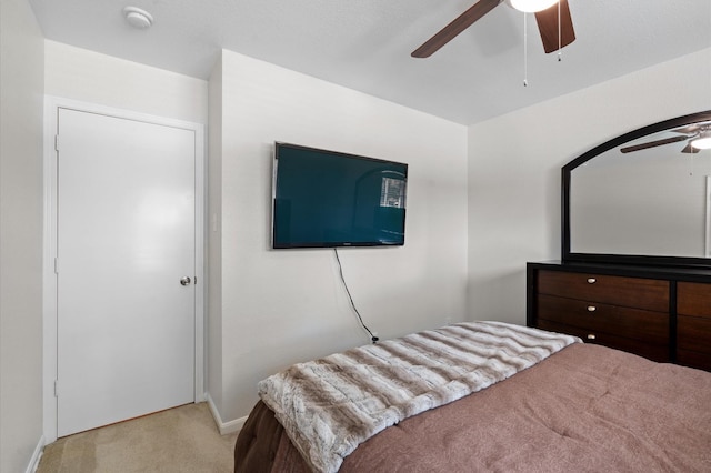 bedroom featuring light carpet and ceiling fan