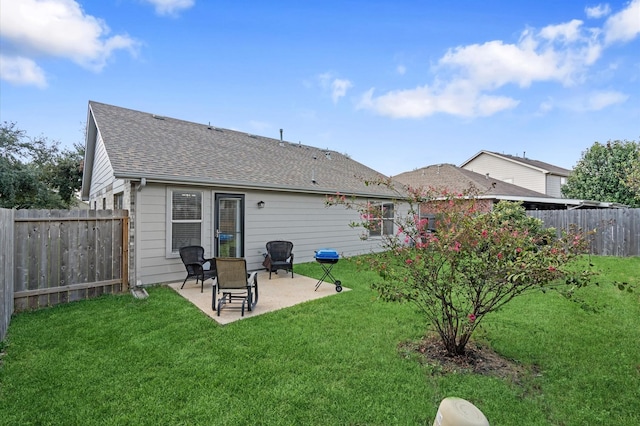 back of house with a yard and a patio area