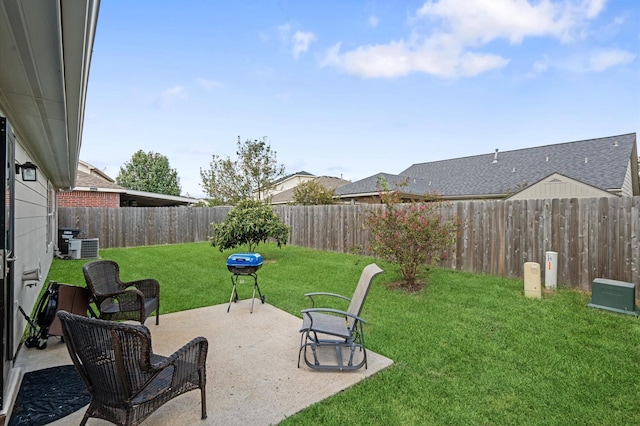 view of yard with central AC unit and a patio area