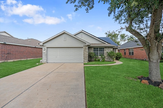 ranch-style home featuring a garage, solar panels, and a front yard