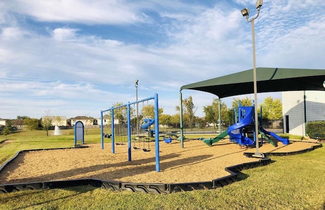 view of playground with a lawn