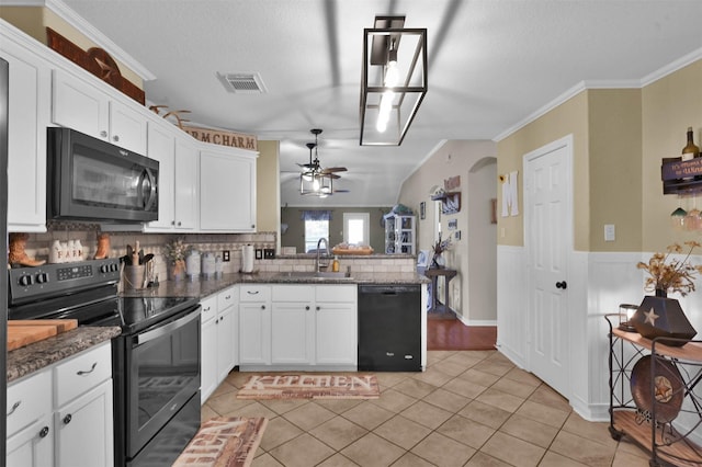 kitchen featuring black appliances, kitchen peninsula, white cabinets, and sink