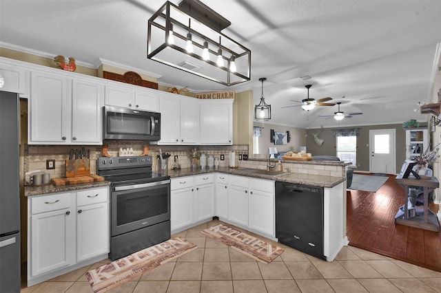 kitchen with appliances with stainless steel finishes, hanging light fixtures, kitchen peninsula, light tile patterned floors, and white cabinets