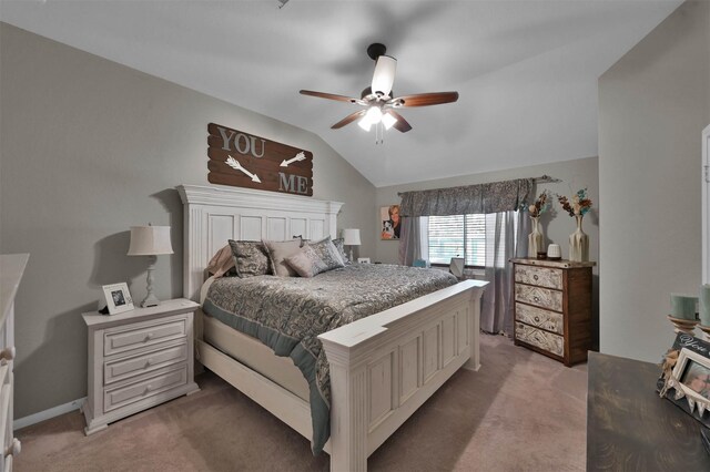 carpeted bedroom with ceiling fan and vaulted ceiling