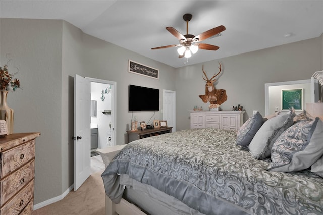 carpeted bedroom featuring connected bathroom and ceiling fan