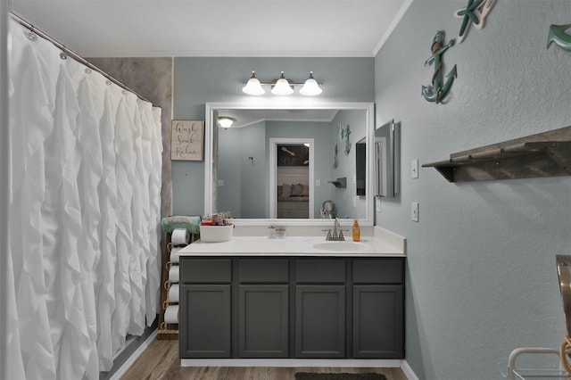 bathroom featuring ornamental molding, a shower with curtain, vanity, and hardwood / wood-style flooring