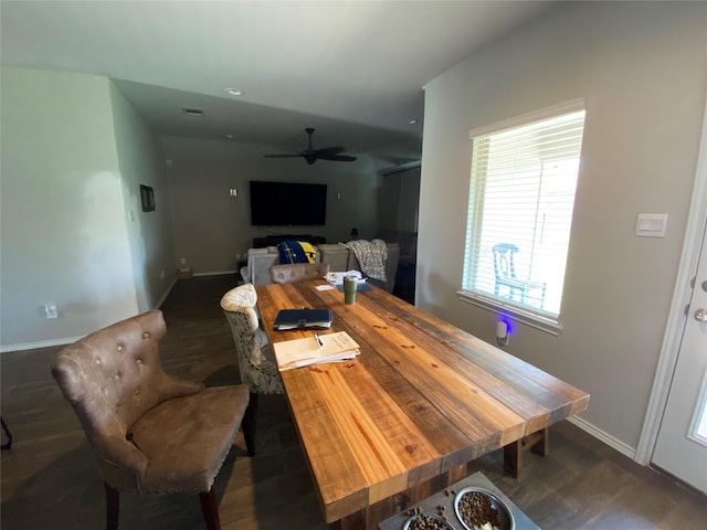 dining room with ceiling fan and dark hardwood / wood-style flooring