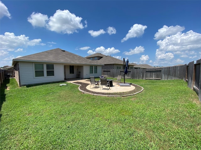 back of property with a patio area and a lawn