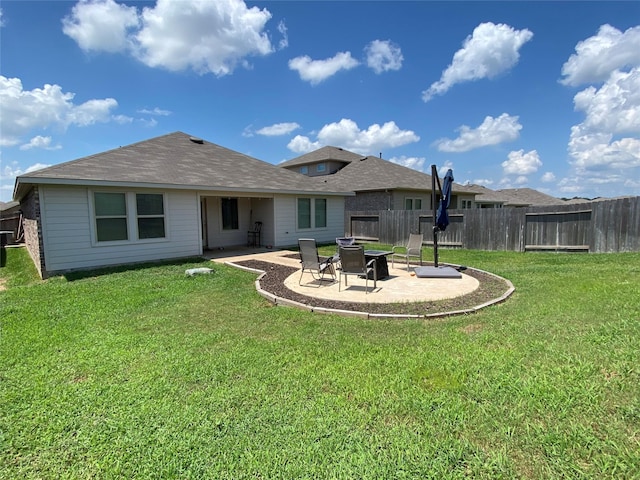 back of property featuring a patio and a yard