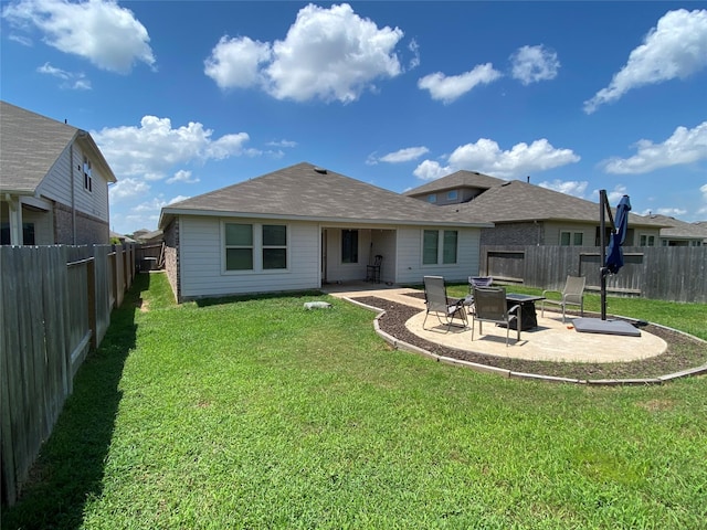 back of property with a patio and a yard