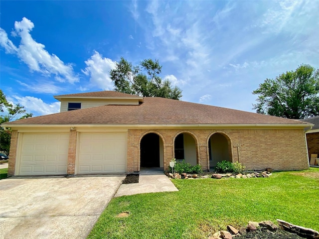 view of front of house with a garage and a front yard