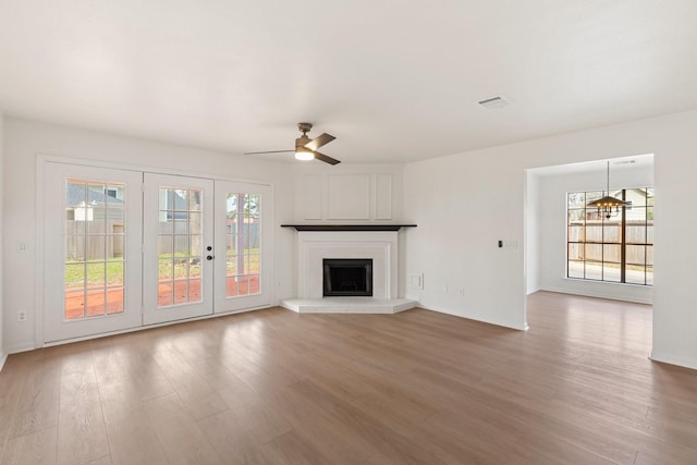 unfurnished living room with ceiling fan and hardwood / wood-style flooring