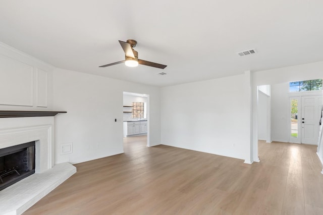 unfurnished living room with ceiling fan and light wood-type flooring