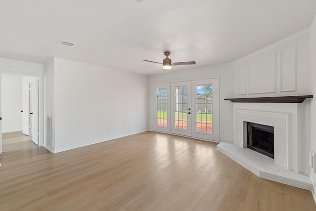 unfurnished living room featuring light hardwood / wood-style flooring, french doors, and ceiling fan