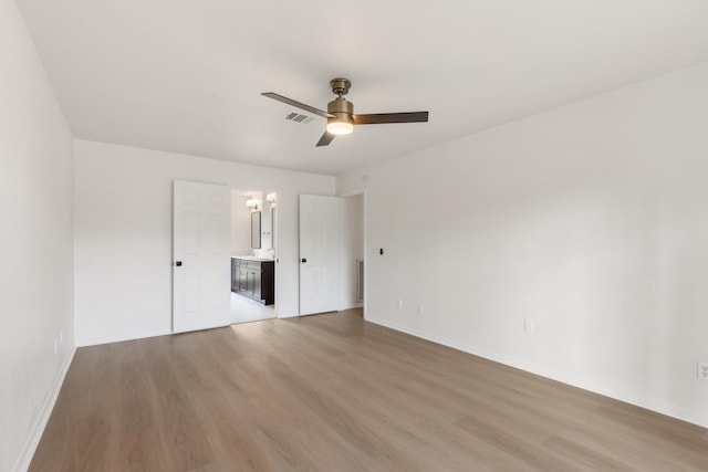 unfurnished bedroom featuring ceiling fan, connected bathroom, and light hardwood / wood-style floors