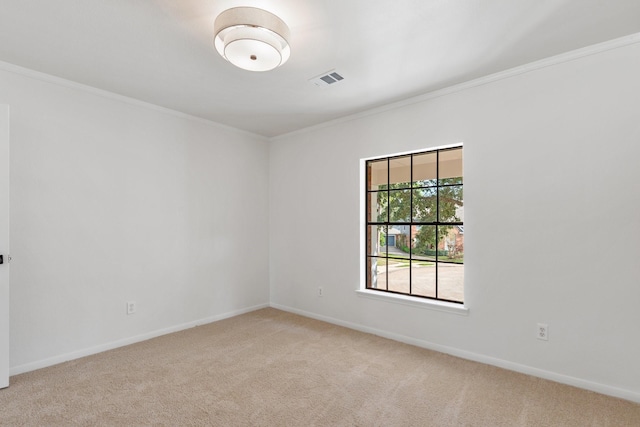 spare room featuring crown molding and light colored carpet