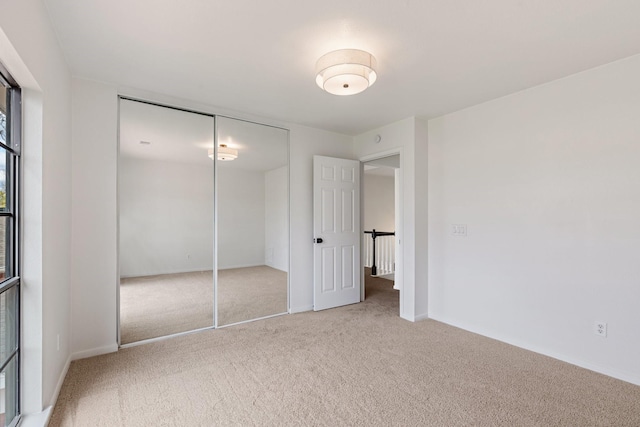 unfurnished bedroom featuring a closet and carpet flooring