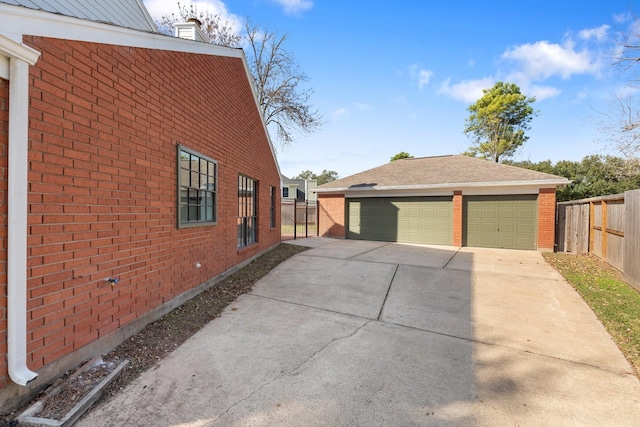 view of side of property featuring a garage and an outdoor structure