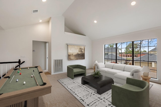 carpeted living room with high vaulted ceiling