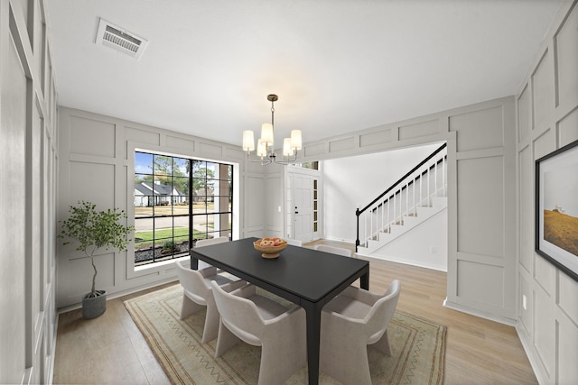 dining area featuring a chandelier and light wood-type flooring