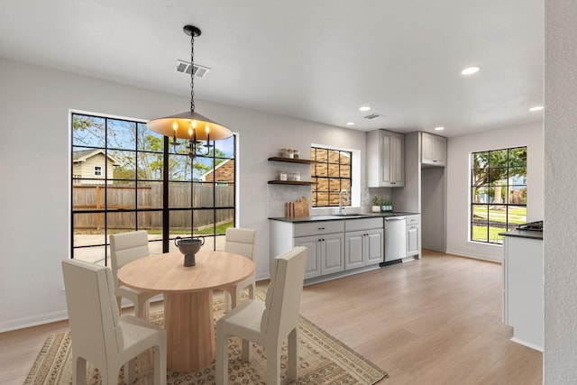 dining room featuring sink and light hardwood / wood-style flooring