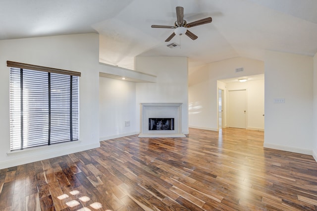 unfurnished living room featuring wood-type flooring, ceiling fan, and vaulted ceiling