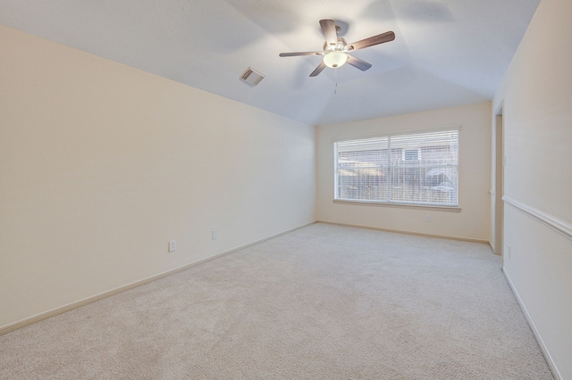 carpeted spare room with vaulted ceiling and ceiling fan