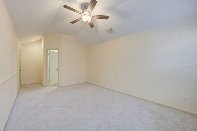 additional living space with lofted ceiling, light carpet, and ceiling fan