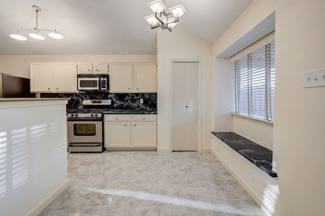 kitchen with a chandelier, decorative light fixtures, stainless steel appliances, tasteful backsplash, and lofted ceiling