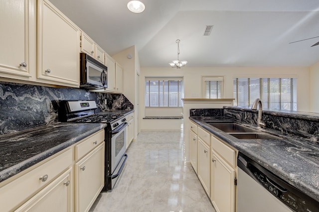 kitchen with cream cabinets, decorative light fixtures, backsplash, appliances with stainless steel finishes, and sink