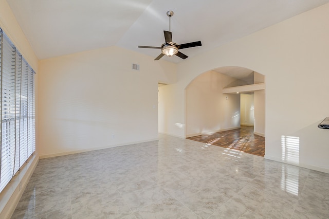 empty room with ceiling fan and vaulted ceiling