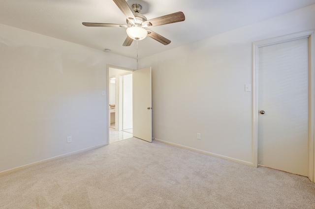 empty room with ceiling fan and light carpet