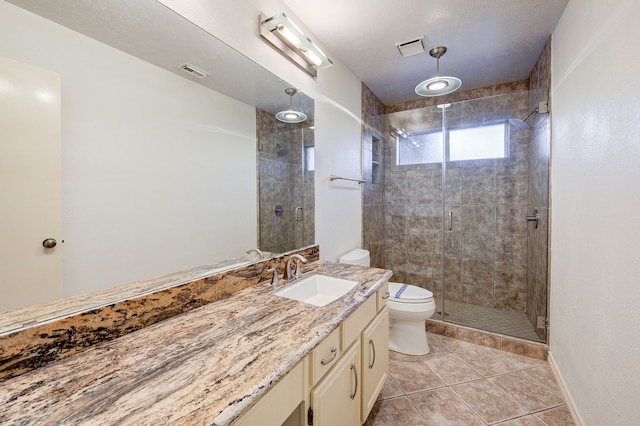 bathroom featuring walk in shower, tile patterned flooring, vanity, and toilet