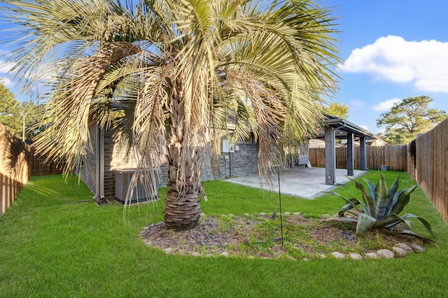 view of yard with central air condition unit and a patio area