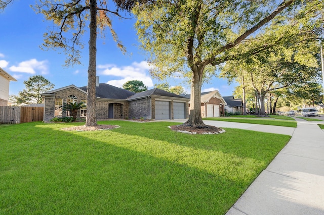 ranch-style house featuring a front lawn and a garage