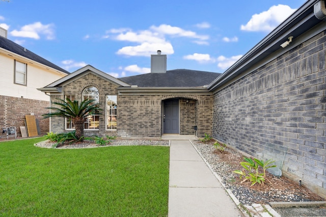 doorway to property featuring a yard