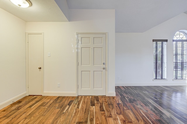 unfurnished room with dark hardwood / wood-style flooring