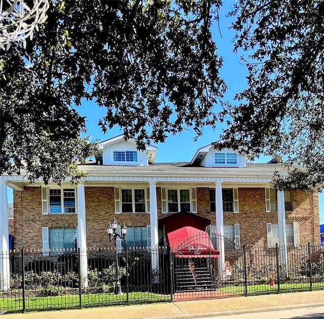 view of building exterior featuring a fenced front yard