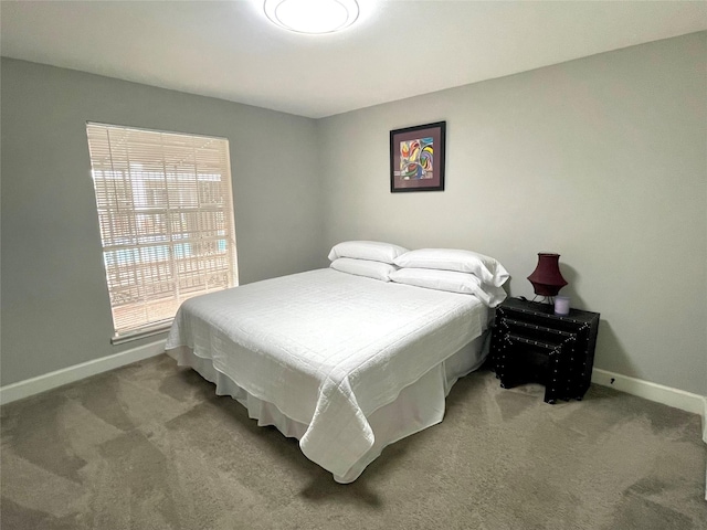 bedroom with baseboards and carpet