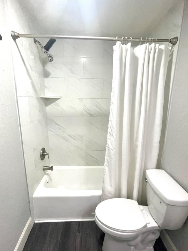 full bath featuring toilet, shower / tub combo, baseboards, and wood finished floors