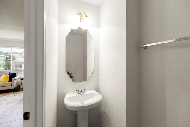 bathroom with crown molding and tile patterned floors