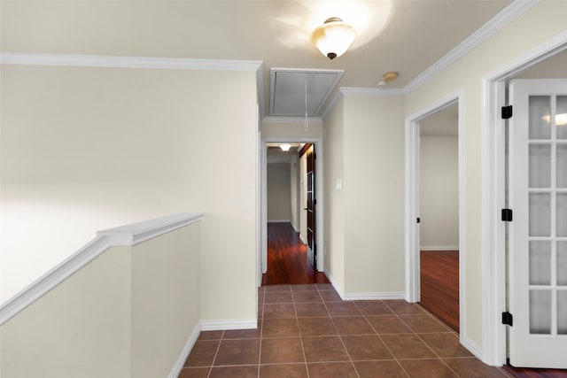 hall featuring dark tile patterned floors and ornamental molding