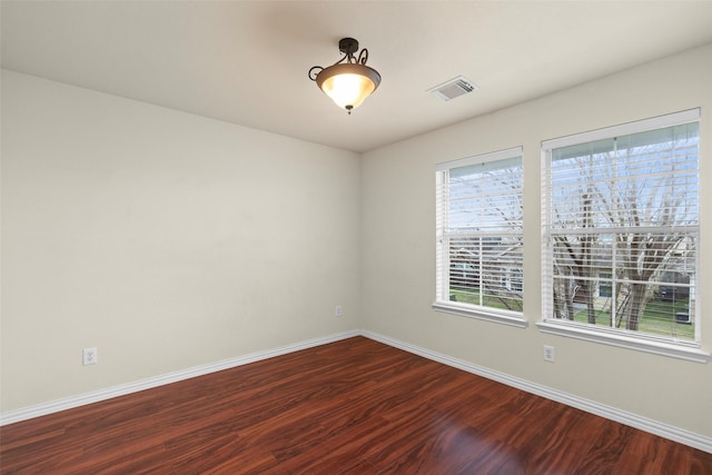 spare room featuring wood-type flooring