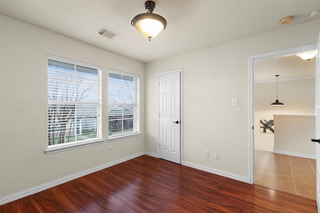 unfurnished room featuring dark hardwood / wood-style floors